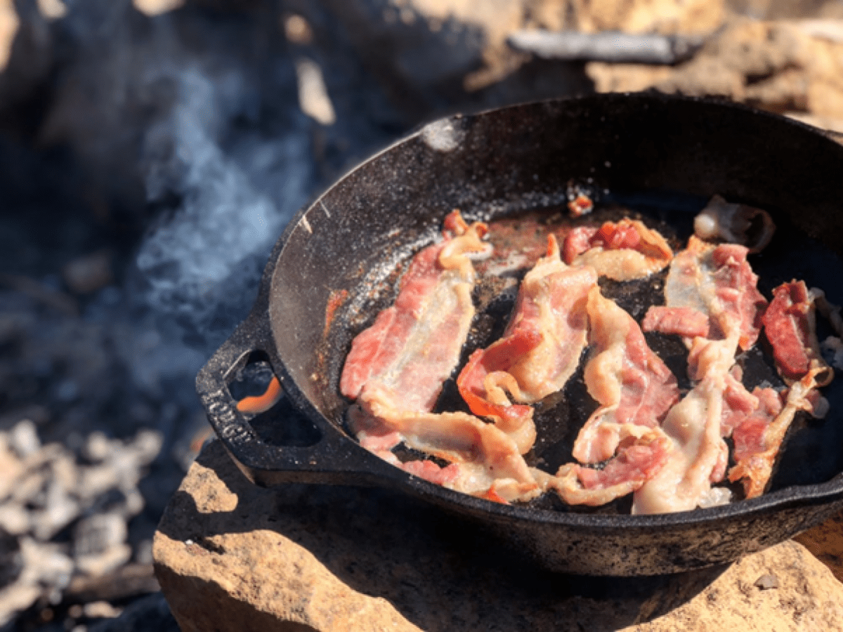 Bacon frying in a cast iron pan